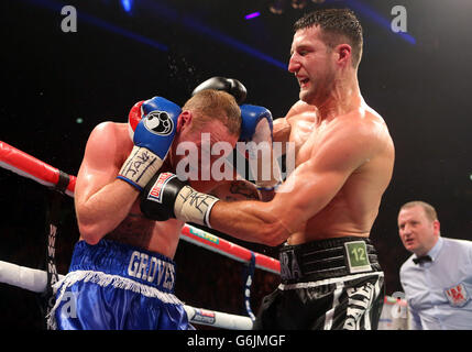 Carl Froch (right) and George Groves during the WBA and IBF Super Middleweight Title fight at the Phones 4u Arena, Manchester. Stock Photo