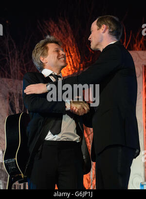 The Duke of Cambridge (right) shakes hands with Jon Bon Jovi after singing with him and Taylor Swift (not pictured) at the Centrepoint Gala Dinner at Kensington Palace, London. Stock Photo