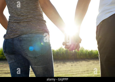 Couple holding hands taking walk together Stock Photo