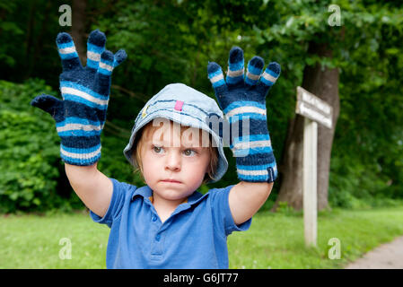 Little boy wearing oversized winter gloves, portrait Stock Photo