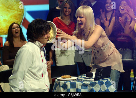 Actress Mena Suvari throws a plate of mashed potato in a fan's face during an 'American Pie' game during her guest appearance on MTV's TRL UK at the MTV Studios in Camden, north London. The actress is promoting her latest movie 'Spun'. Stock Photo