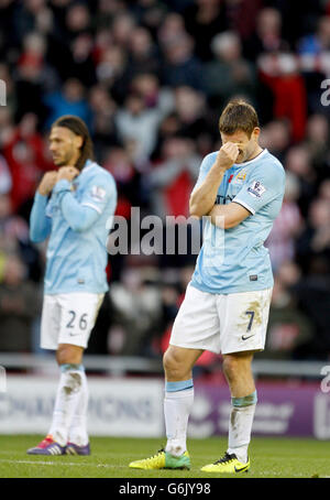 Soccer - Barclays Premier League - Sunderland v Manchester City - Stadium of Light. Manchester City's James Milner (right) and Martin Demichelis dejected after the final whistle Stock Photo