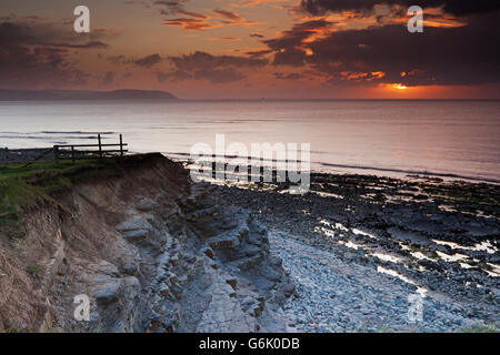 Sunset on a cloudy and showery evening at Kilve Beach, from the cliffs looking out over the Bristol Channel, United Kingdom Stock Photo