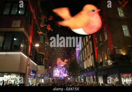 The Christmas decorations on Carnaby Street, London, as they were switched on during The Carnaby Shopping Party. PRESS ASSOCIATION Photo. Picture date: Thursday November 14, 2013. 130 shops and restaurants across 13 streets in the area came together to celebrate Christmas in Carnaby. The 3D robin decorations were switched on by DJ Goldierocks via a virtual countdown of the top ten Christmas songs and videos voted for by the Carnaby social media followers. Photo credit should read: Matt Alexander/PA Wire Stock Photo