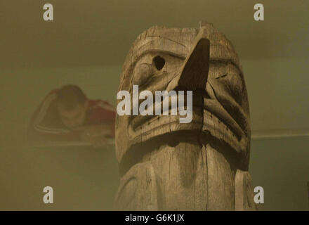 Part of an early and important totem pole from the Nisga'a Nation in British Columbia, at a ceremony inside the British Museum in central London. The pole, dating from around 1850, was acquired by the museum in 1933 but has never before been seen by the public. The eight metre red cedar pole will be one of the star objects in the museum's forthcoming 'Living and Dying' exhibition opening on November 3. Stock Photo