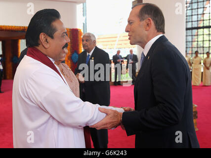 Australian Prime Minister Tony Abbott is greeted by President Mahinda Rajapaksa of Sri Lanka, at the Commonwealth Heads of Government Meeting (CHOGM), at the Nelum Pokuna Theatre in Colombo, Sri Lanka. Stock Photo