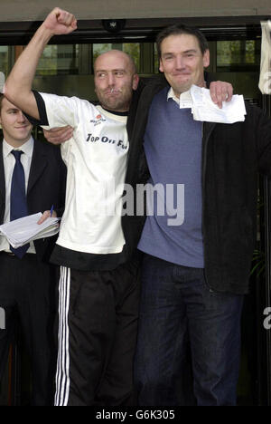 David Chick (left), 36, celebrates with a friend after having been granted bail by magistrates at Thames Magistrates Court in east London, where he was charged with causing a public nuisance. Chick, of Burgess Hill, West Sussex, spent six days on a crane at St Katherine's Way, Tower Bridge, London, to protest about fathers' rights to have access to their children. Stock Photo