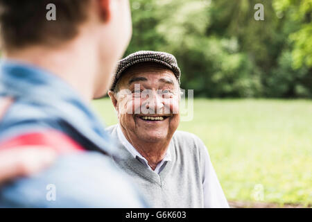 Portrait of senior man talking with his grandson Stock Photo