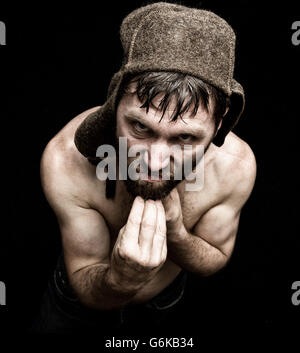 Dark portrait of scary evil sinister bearded man with smirk, makes various hand's signs and expresses different emotions. strange Russian man Stock Photo