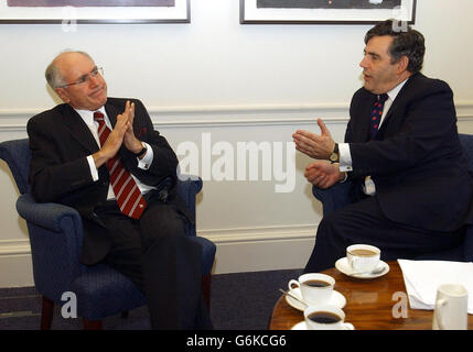 Chancellor Gordon Brown (right) talks with Australian Prime Minister John Howard at a meeting in the Treasury, London. Stock Photo