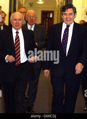 Chancellor Gordon Brown (right) arrives with Australian Prime Minister John Howard for a meeting at the Treasury in London. Stock Photo