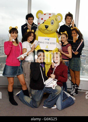 NO MERCHANDISING. Pop group S Club 8 launch the BBC Children In Need donation line number with Pudsey the Bear, from the top of the BT Tower, central London. BT expect to handle 200,000 calls tomorrow night at 60 call centres across the UK. Stock Photo