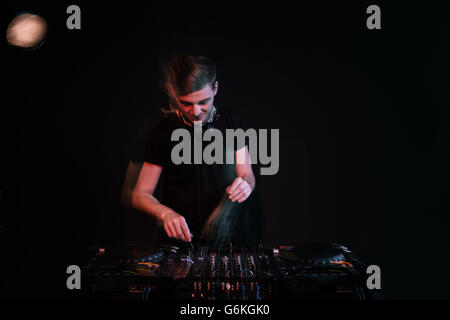 Dj using turntables and mixing tracks over black background Stock Photo