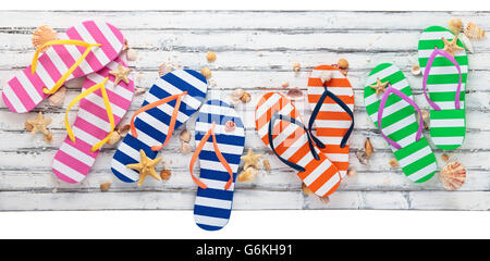 White wood with summer flip flops and seashells on it. Stock Photo