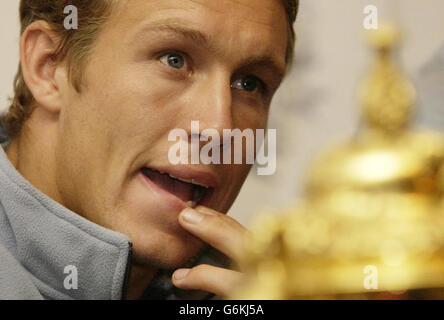 World Cup hero Jonny Wilkinson sits with the William Web Ellis trophy as he speaks at a news conference at Penny Hill Park Hotel near Bagshot after the England rugby team returned from Sydney. Earlier, thousands of people were at Heathrow Airport to welcome home the team that beat Australia in extra time on Saturday to win the Rugby world Cup. Stock Photo