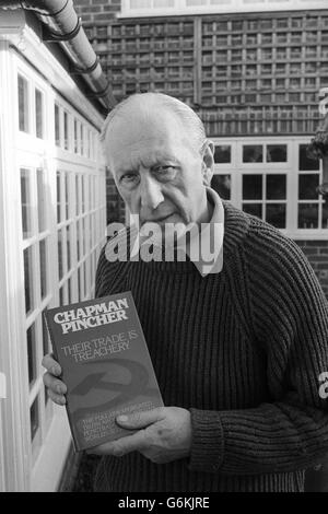 Author and journalist Chapman Pincher picture at his home holding a copy of his book 'Their Trade Is Treachery' which was published in 1981. Stock Photo