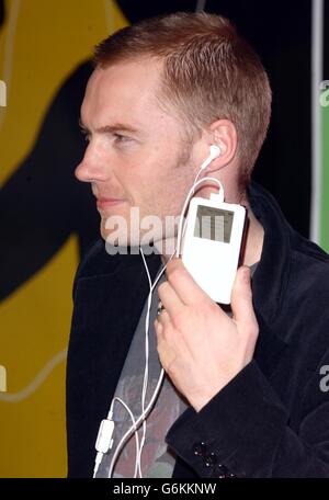 Singer Ronan Keating with the new 40GB Apple iPod which holds 10,000 songs at Virgin Megastore in London's Oxford Street. Ronan switched on the iPod which will play in the store continuously for 28 days until 24th Decmeber 2003. 21/12/03: Shops are struggling to cope with demand for a hi-tech personal stereo which has become the must-have gadget of the year, it emerged. Factories are working flat out to satisfy demand for the three models in the iPod range which cost between 249 and 399. The iPod, made by Apple, is a music player which can store up to 10,000 individual songs in a machine Stock Photo
