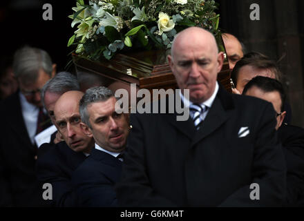 The coffin of Captain David Traill, the pilot killed in the Glasgow helicopter crash, is carried during his funeral at Glasgow University. Stock Photo