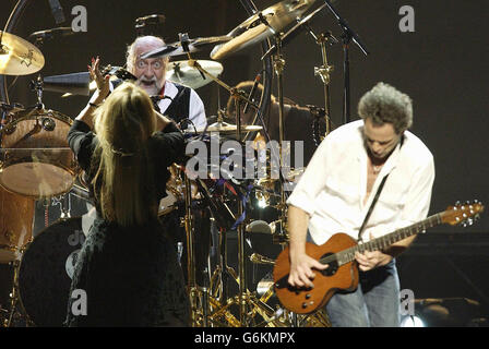 (From left to right) Stevie Nicks, Mick Fleetwood (on drums) and Lindsay Buckingham from band Flletwood Mac perform live in concert at Earls Court in west London. It is the band's first UK tour since 1988. Stock Photo