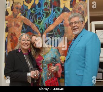 Artist Rolf Harris with his wife Alwen and daughter Bindin standing in front of a work by Bindin entitled 'Alchemy' during the launch party of Lang Gallery At The Factory in Shoreditch, east London . Stock Photo