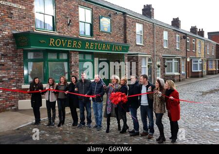 Cast members from Coronation Street stand behind a ribbon on the new set during a photocall at Media City, Manchester. Stock Photo