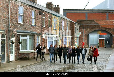 Cast members from Coronation Street walk along the cobbles of the new set during a photocall at Media City, Manchester. Stock Photo