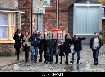 Cast members from Coronation Street walk along the cobbles of the new set during a photocall at Media City, Manchester. Stock Photo