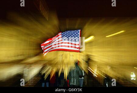 A Pro American holds up an USA flag as President Bush arrives at Buckingham Palace for a three day state visit. Stock Photo