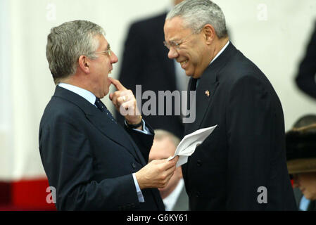 Home Secretary Jack Straw (left) shares a joke with American Secretary of State Colin Powell before a ceremonial welcome for US President George W Bush at Buckingham Palace, London. A massive security operation is in place in the capital for the state visit of America's President Bush, who is staying at the Palace as a guest of The Queen. Stock Photo