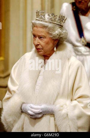 Queen Elizabeth II makes her way from the Sovreign's entrance, up the stairs towards the Norman porch, ahead of making the Queen's Speech, to members of the House of Lord and the House of Commons during the State Opening of Parliament in London. Seated on the Throne in the House of Lords, she formally announced the UK Government's legislative programme for the new parliamentary session. Stock Photo