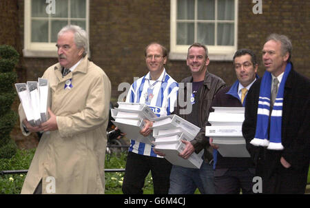 TV football host Des Lynam, left, and DJ Norman Cook, aka Fatboy Slim, centre, arrive in Downing Street with fellow supporters, from second left, Tim Carder, Paul Samrah and Lord Bassam of Brighton, to deliver a 62,000 signature petition requesting Government approval for a new stadium for their beloved Brighton and Hove Albion FC. The Second Division club, who currently play at an athletics stadium at Withdean, want to build a multi-purpose 25,000-seat stadium at Falmer. Stock Photo