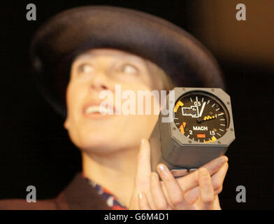 British Airways cabin crew member Emma Ridges holds up a Concorde Jaeger Machmeter, which was sold for 28,000 - 24,000 more than expected - at the British Airways Concorde Charity Auction by Bonhams auctioneers at Olympia in London. With nearly every lot going for far more than its estimated price, the sale was expected to easily surpass the anticipated total of about 500,000. Stock Photo