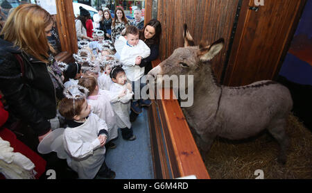 Children from St Josephs Nursery school meet the animals during the opening of the Irish Farmers Association Live Animal Crib at the Mansion House in Dublin. Stock Photo