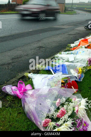 Road-side floral tributes to Stephanie Hammill, left at the scene in in Wakefield, West Yorkshire, after Ms Hammill was abducted by a taxi driver whilst walking with her boyfriend and was found lying dead in a road minutes later after being hit by a car. Stephanie Hammill, 20, of Wakefield, flagged down what she thought was a taxi with her boyfriend in the early hours of Saturday morning in Balne Lane, she got into the back seat and left the door open for her boyfriend to get in but the car sped off. Stock Photo