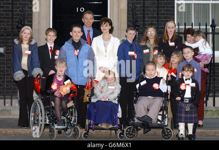 The Prime Minister Tony Blair and his wife Cherie with the Woman's Own Children of Courage 2003 outside 10 Downing Street, London. In all rows the children are listed from left to right. Front row seated; Laura Brewin from Leicester, Melissa Craven from Stockport, Steven O'Shea from Southend -On-Sea, Samuel Bell from Glasgow. Middle row; Kirsty Carlisle from Preston, John Lyons from Sevenoaksin Kent, Nicolas Hyslop from Midlothian, Liam Southall from Dudley, Bethan Ramm from Wrexham (pigtails), Emma Mawdsley from Ripon, Shay Corrie from Tyne and Wear. Rear right row Rachel Mawdsley ( sister Stock Photo