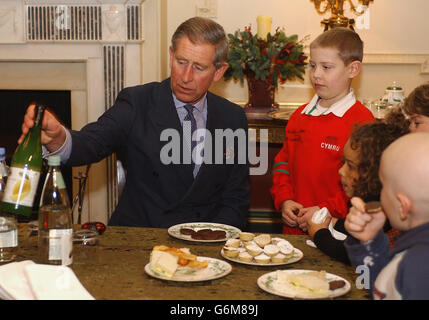 The Prince of Wales has tea with eight-year-old Jack Seymour (red top) and other children at a reception for ill children, at Clarence House, London. Mrs Parker Bowles, who was visiting the Prince for the day at his London residence, made the unexpected appearance as the children and their parents enjoyed the festive gathering. Stock Photo