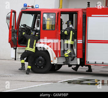 fire engine carrying firefighters and equipment for fighting fire Stock Photo