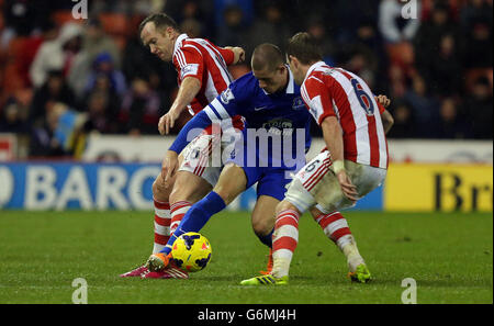 Stoke City's Glenn Whelan is challenged by Burnley's Matthew Taylor ...