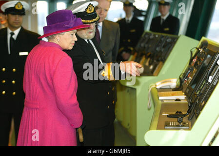 Queen Elizabeth II with Commador Ronald Warwick on the bridge of the Queen Mary 2 cruise liner in Southampton Docks, before naming the 550 million vessel in front of more than 2,000 guests. It was the first time the Queen had named a Cunard ship since the launch in 1967 of the QE2, whose Southampton to New York service will be taken over by the 2,620-passenger QM2 in April. Stock Photo