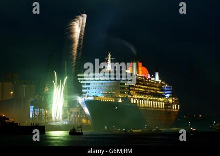 Flood lights and fireworks light up the new Cunard Liner, Queen Mary 2, in Southampton, after the vessel, the biggest ever built at almost three times the size of the Titanic, was named by Queen Elizabeth II. It was the first time the Queen had named a Cunard ship since the launch in 1967 of the QE2, whose Southampton to New York service will be taken over by the 2,620-passenger QM2 in April. Stock Photo