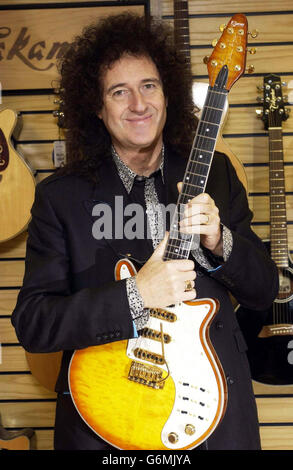Queen guitarist Brian May, who officially opened the new House of Guitars store, in Brune Street, central London. May holds a custom built Burns Brian May Honey Sunburst guitar. 10/01/04: From a garage near you, Britain is pounding to the beat of rock revival, and guitar sales are soaring as teenagers - and their fathers - learn to hammer out their favourite riffs. Specialist chain House of Guitars has experienced such a huge surge in demand that it has now moved its London branch from Wapping, where it was sited for the last 20 years, to the Square Mile, the home of stockbrokers and bankers. Stock Photo