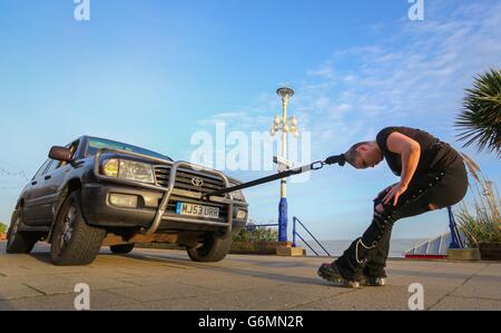 Circus of Horrors performer pulls car with hair Stock Photo