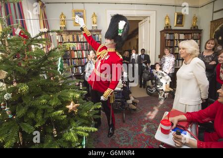 Lieutenant Frederick Lloyd George, helps decorate a Christmas Tree at Clarence House in London, at a reception hosted by the Duchess of Cornwall, for youngsters and their carers from Helen and Douglas House. Stock Photo