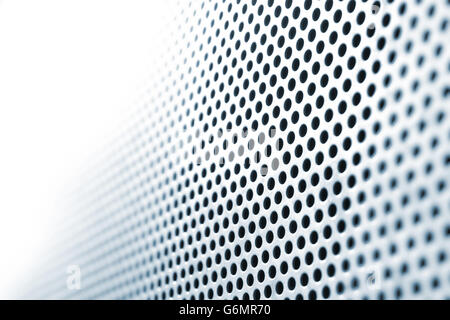 Abstract steel plate with circle holes, in shifting focus, fading into absolute white. Stock Photo