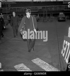 Ringo Starr, drummer of The Beatles, signs off - with the aid of BEA - as he about to board an airliner at London Airport to join the three other members of the group in Paris. The other Beatles flew out yesterday, while Ringo Starr was fog-bound in Liverpool and unable to get to London in time to travel with them. Stock Photo