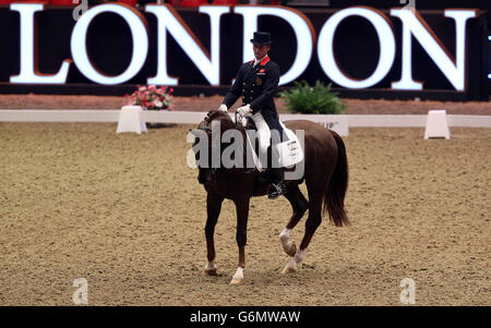 Great Britain's Carl Hester riding Fine Time 13 competes in the REEM ACRA FEI World Cup Dressage Grand Prix during The London International Horse Show, at the Olympia Exhibition Hall, West Kensington, London. Stock Photo