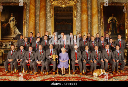Britain's Queen Elizabeth II poses, with the England rugby squad at a reception at Buckingham Palace in London to celebrate winning the Rugby World Cup. Earlier the squad had paraded the trophy through the West End in a procession of open-topped buses. Back row (L-R): Jason Robinson, Julian White, Trevor Woodman, Steve Thompson, Mike Catt, Iain Balshaw, Dan Luger, Stuart Abbott, Andy Gomarsall, Josh Lewsey and Jason Leonard. Centre row ( L-R): Mike Tindall, Ben Cohen, Joe Worsley, Martin Corry, Ben Kay, Danny Grewcock, Will Greenwood, Lewis Moody, Richard Hill, Mark Regan and Simon Shaw. Stock Photo
