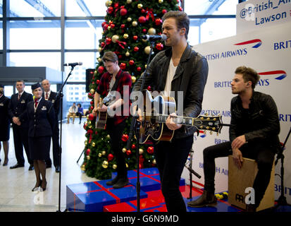 British band Lawson perform a surprise pop up Christmas concert for British Airways customers at Gatwick airport in West Sussex. Stock Photo