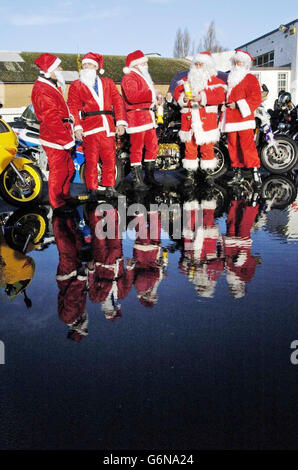 Five bikers dressed in Santa Claus outfits join over a hundred motorcyclists at the Ace Cafe, Brent, north London, to deliver Christmas presents to children at Central Middlesex Hospital, St Mary's Hospital and St Thomas' Hospital. Stock Photo