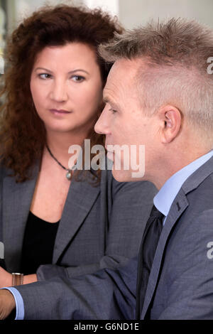 Executive secretary looking worried at business man during a meeting. Stock Photo